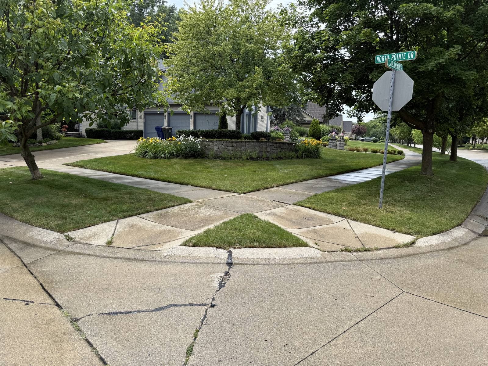 Crisp grass edges along the crisscrossing sidewalks of a corner-lot property